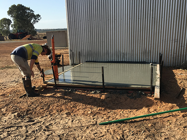 Laying concrete slab for battery room at Bonza Station