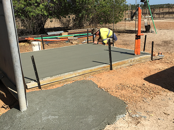 Laying concrete slab for battery room at Bonza Station