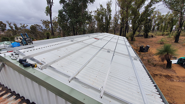 Installing PV array on workshop in Quindanning